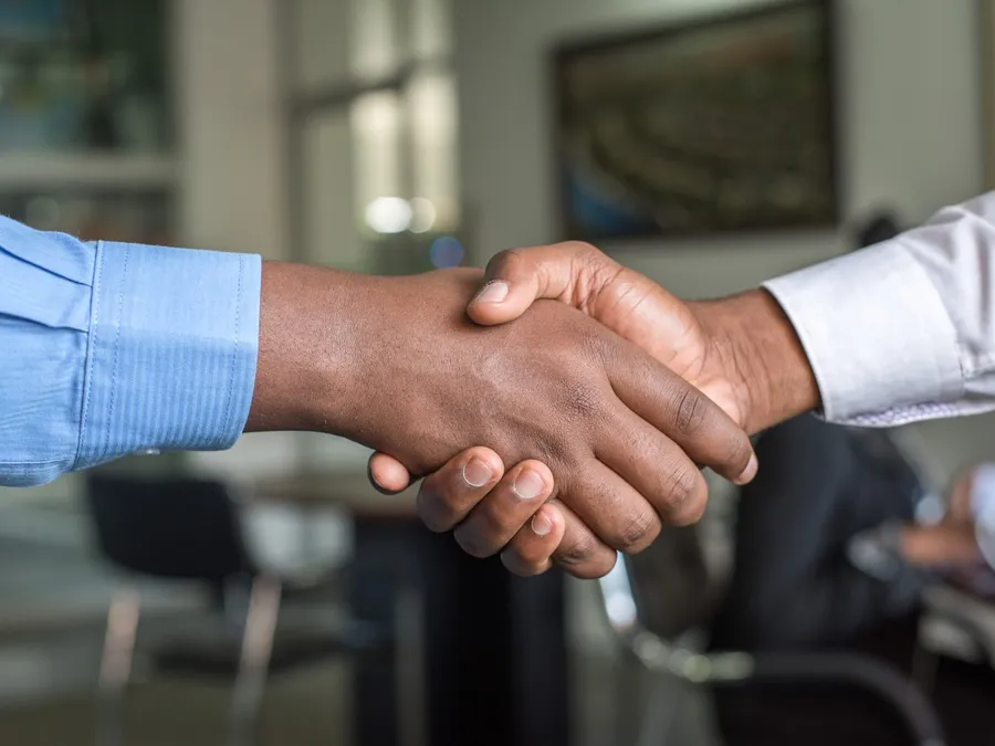 A firm handshake across an office table